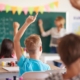 Een aantal kinderen in een klaslokaal, met leerkracht bij het bord